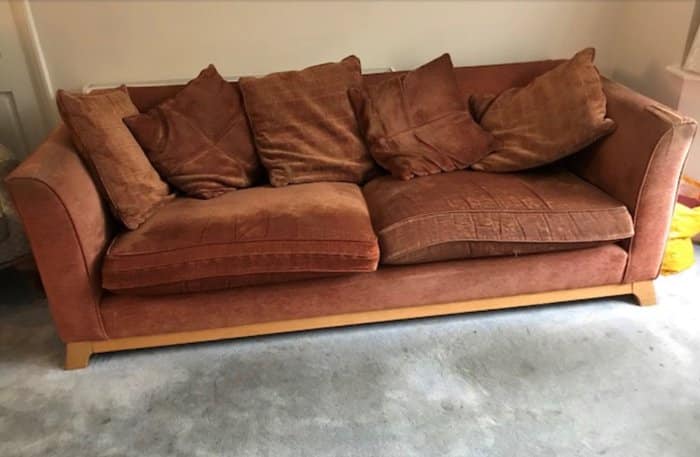 Old brown sofa in need of reupholstering