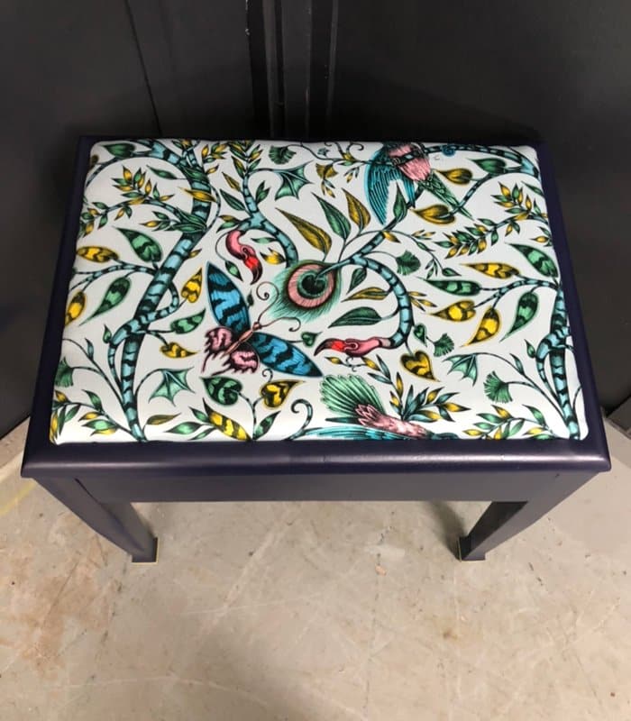 Emma Shipley’s Animalia fabric - The Rousseau print in cotton on a piano stool