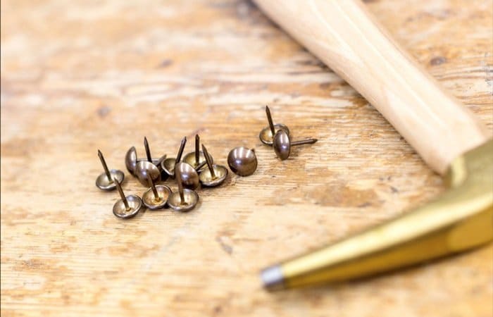 Drawing pins laid out on table - Caroline Jones photography