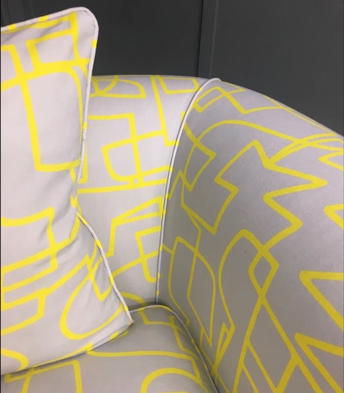 Grey fabric with yellow design on reupholstered cuddle chair