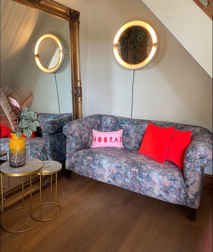 Upholstered Chesterfield sofa with bright cushions