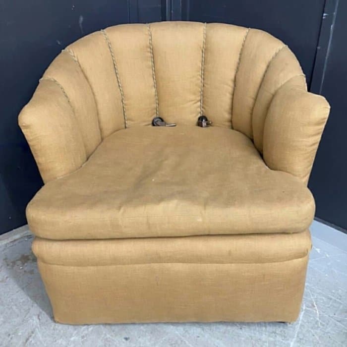 Old bucket armchair in need of reupholstering