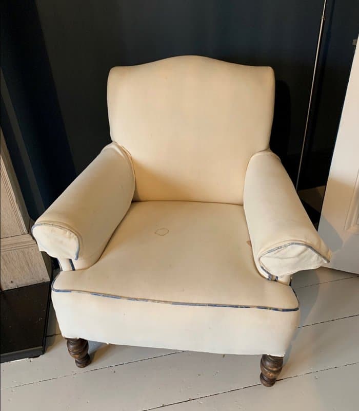 White armchair in need of reupholstering