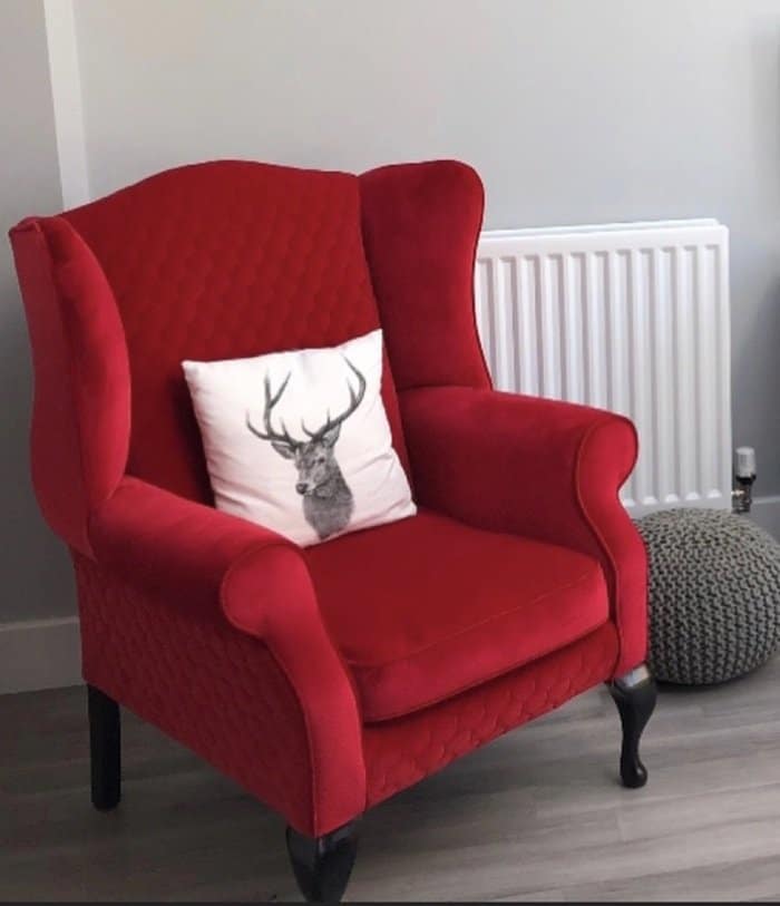 Red reupholstered armchair