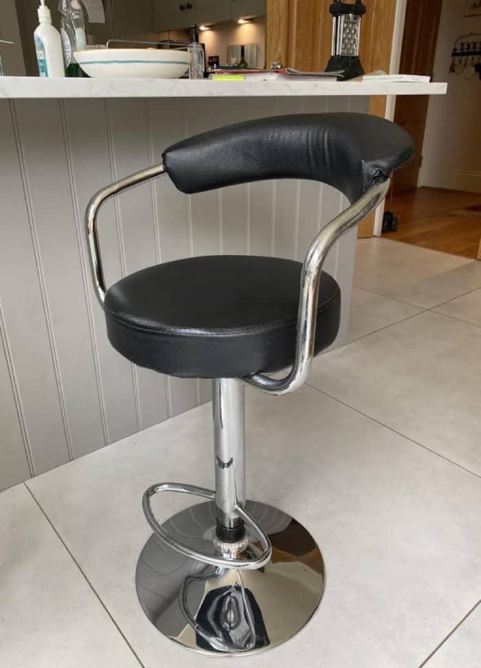 Black leather kitchen stool in need of reupholstering