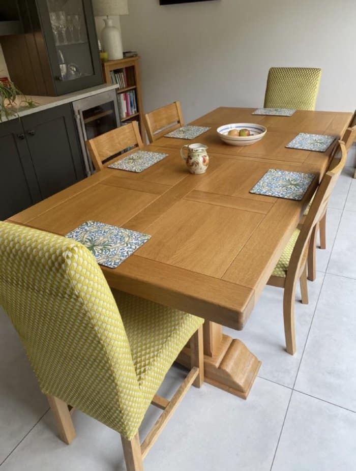 Lime green reupholstered chairs around wood dining room table