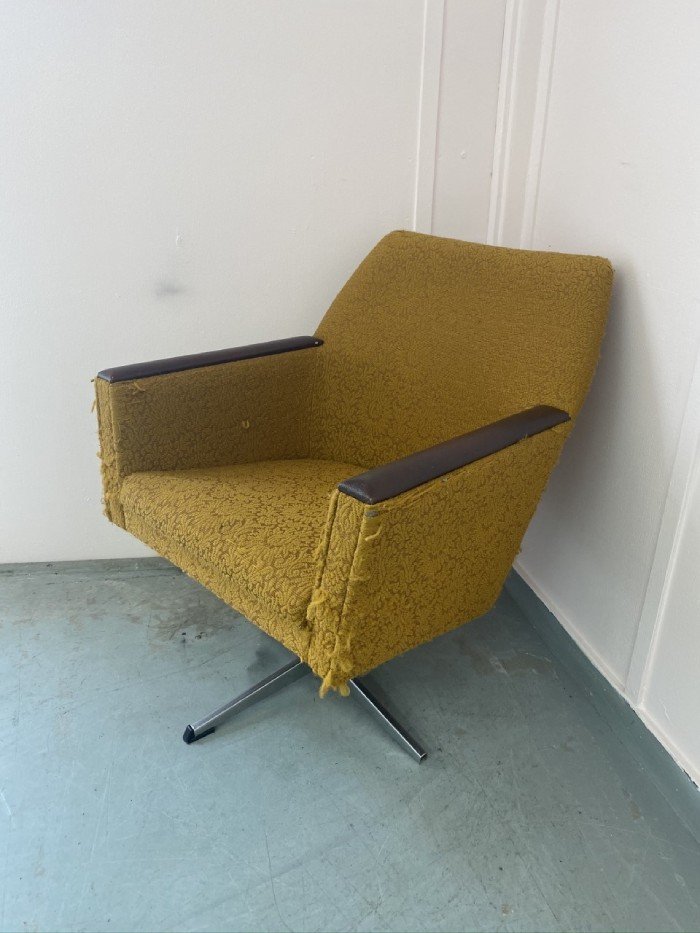 Old yellow armchair in need of reupholstering