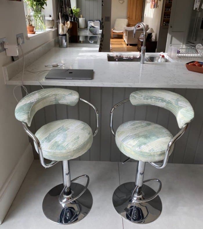Patterned reupholstered kitchen stools in kitchen