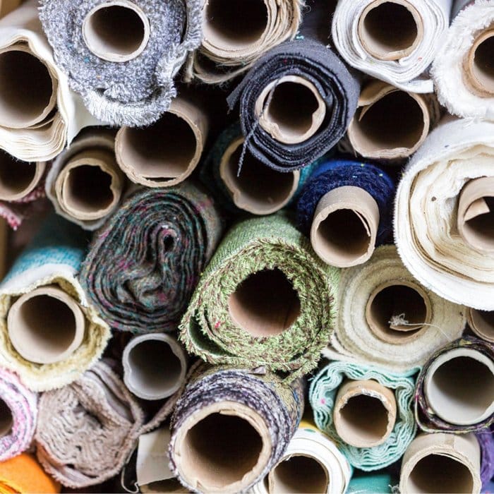 Upholstery fabric supplies stacked up in rolls