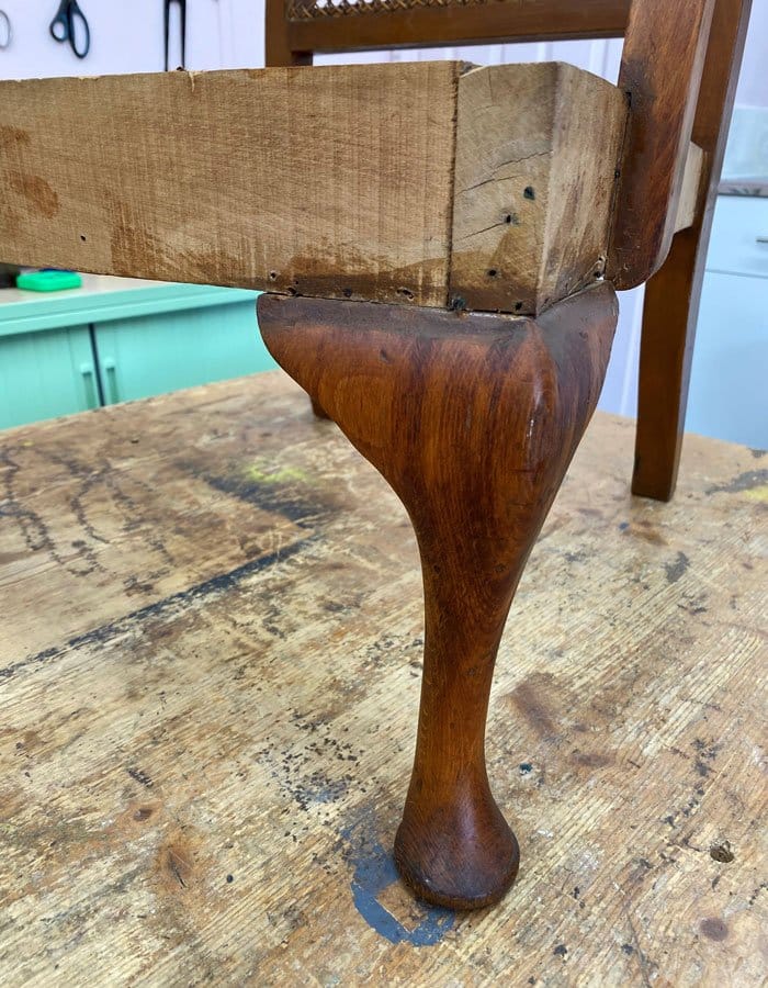 Old wooden chair lega painted and polished during upholstery process