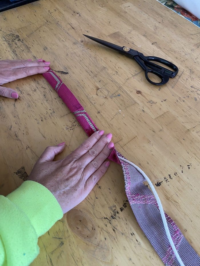 Upholstery piping chord wrapped in fabric with scissors nearby