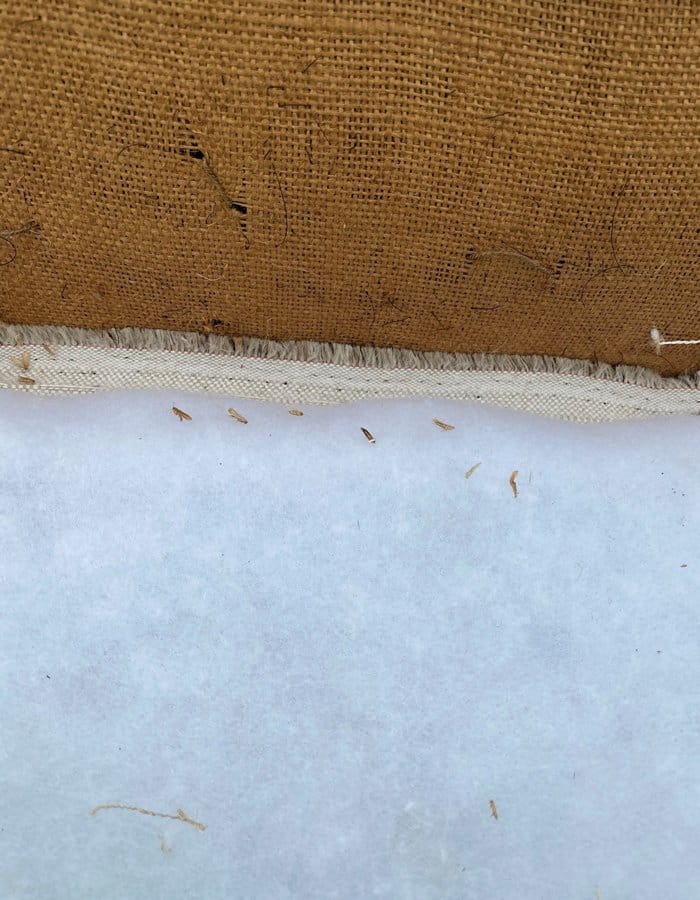 A-moth-bitten-brown-upholstered-chair-700x900