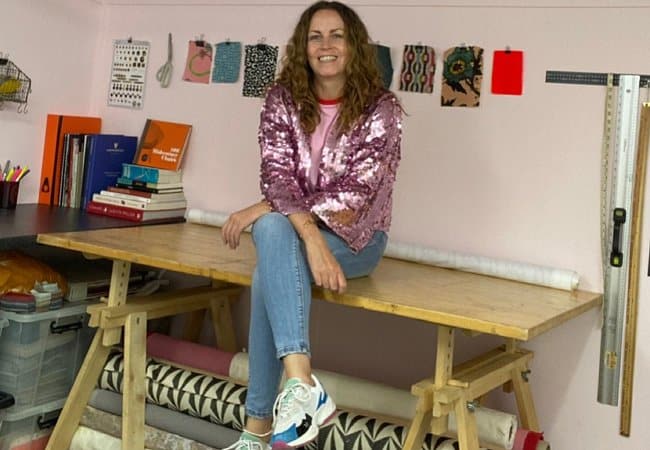Sharon O'Connor sitting on her workbench