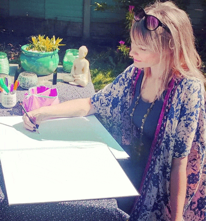 Becca Who designing a fabric pattern outside