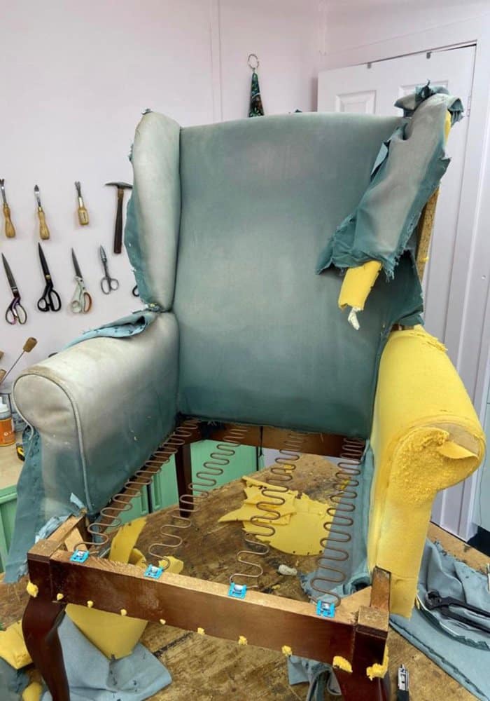 removal of the original fabric before reupholstering a chair