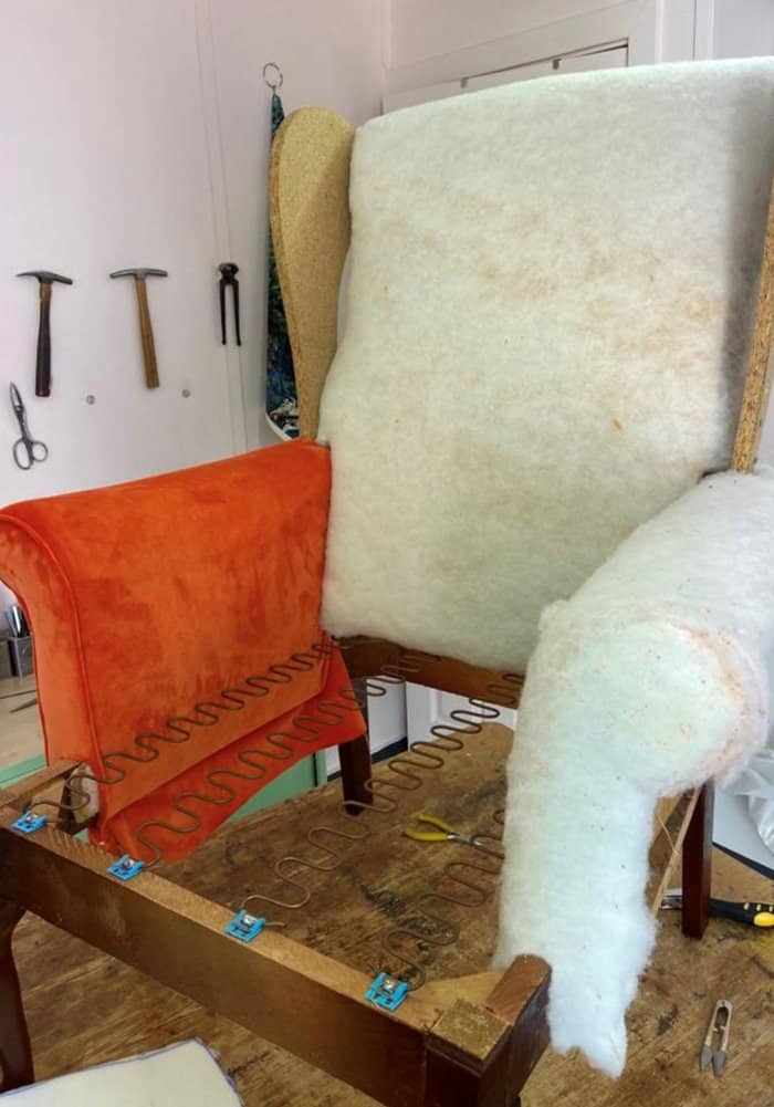 adding polyester and fabric to the arms and arm facers when reupholstering a chair