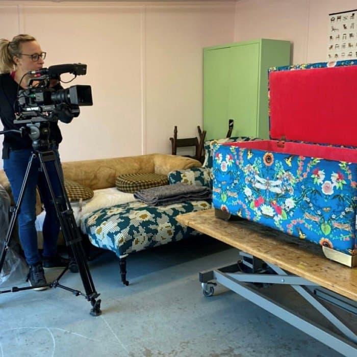 upholstered ottoman being filmed for Money For Nothing