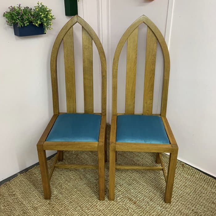 two upholstered chairs with blue drop-in seat pads