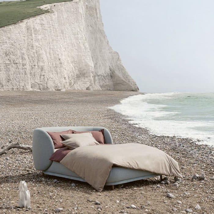 A Kirkby Design bed made out of a eco-friendly fabrics placed on a beach
