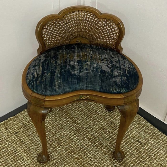 a dressing table stool with black fabric and gold frame for an upholstery project