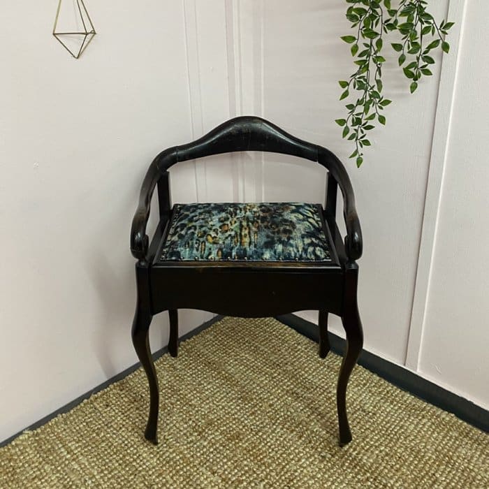 an upholstered piano stool