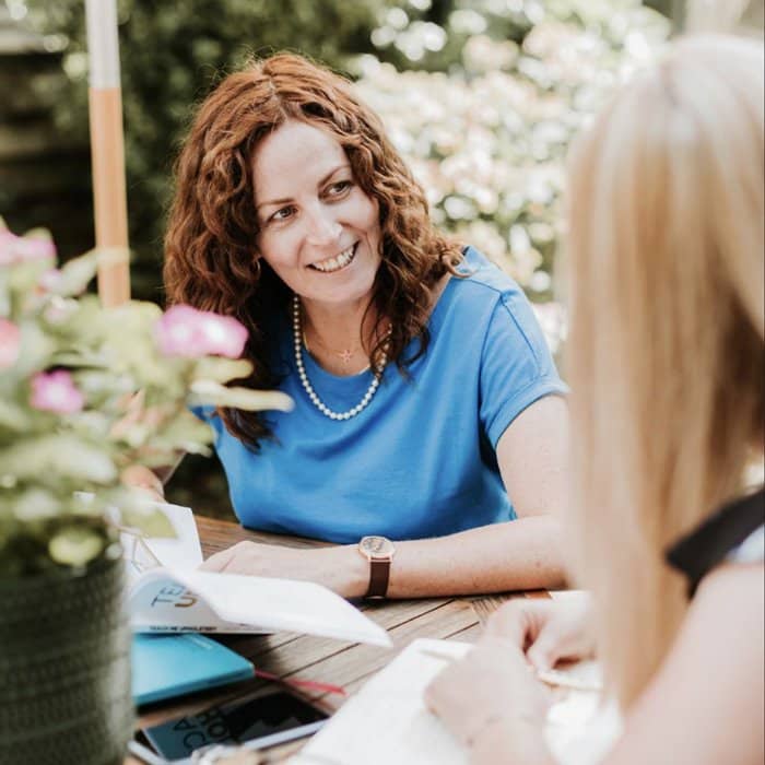 Vintique Upholstery's Sharon O'Connor discussing Power Hour with a fellow upholsterer