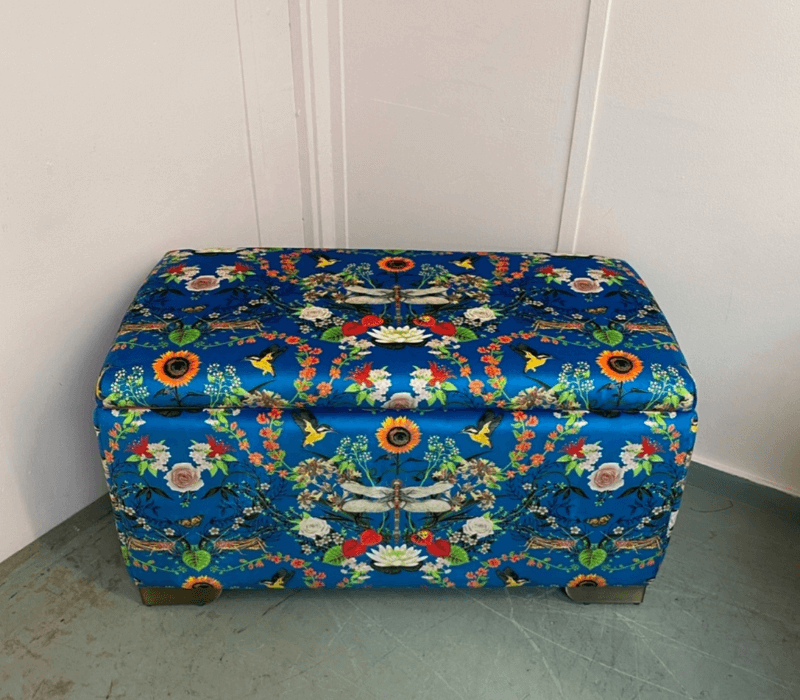 Top view of reupholstered ottoman in Becca Who Garden Treasures print fabric