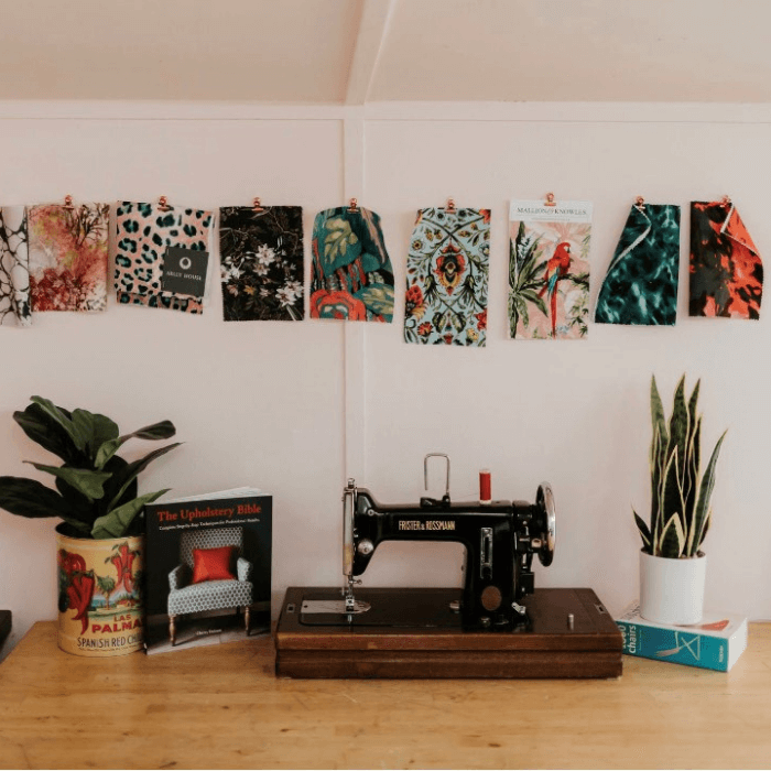 Upholsterer's workshop bench, antique sewing machine, hung fabric samples