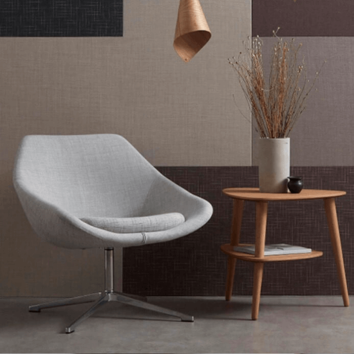 A modern, grey chair upholstered in sustainable fabric from Camira.