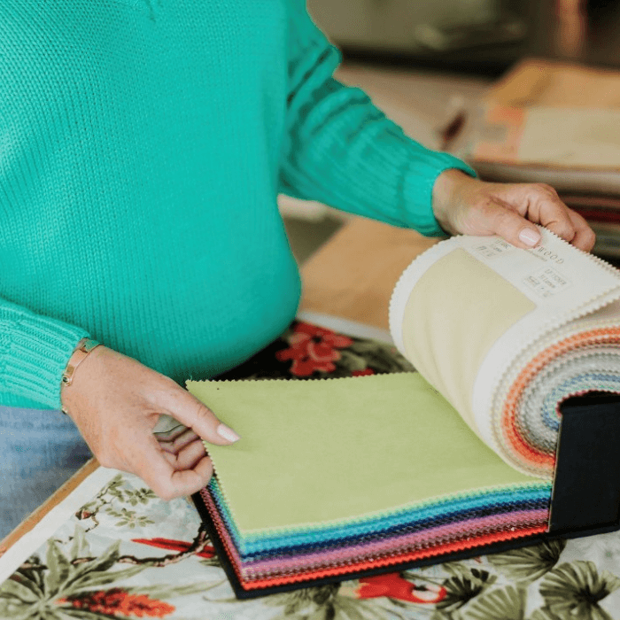 Sharon O'Connor leafs through a fabric sample catalogue from Linwood Fabrics