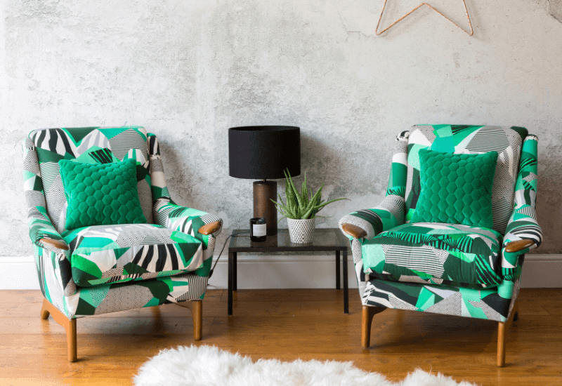 Pair of chairs upholstered in fabric by Kitty McCall, Rousseau.