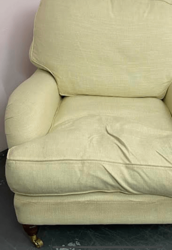 A pre-loved chair awaits reupholstery in the studio.
