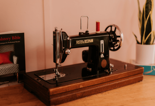 A black antique Frister and Rossmann sewing machine.