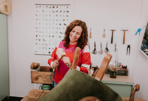 Sharon O'Connor working in the workshop on a client's project: reupholstery of a chair.