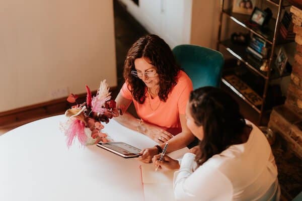 Virtual Vintique – Spring to Success – power hours for upholsterers (1) Sharon with a tablet talking to a female
