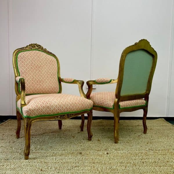 2 antique chairs reupholstered in a patterned fabric with contrast piping