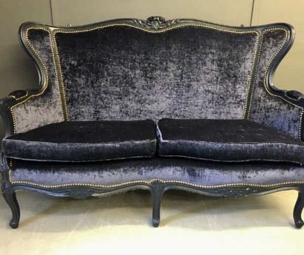 Antique sofa reupholstered in dark blue velvet with studwork and dark legs