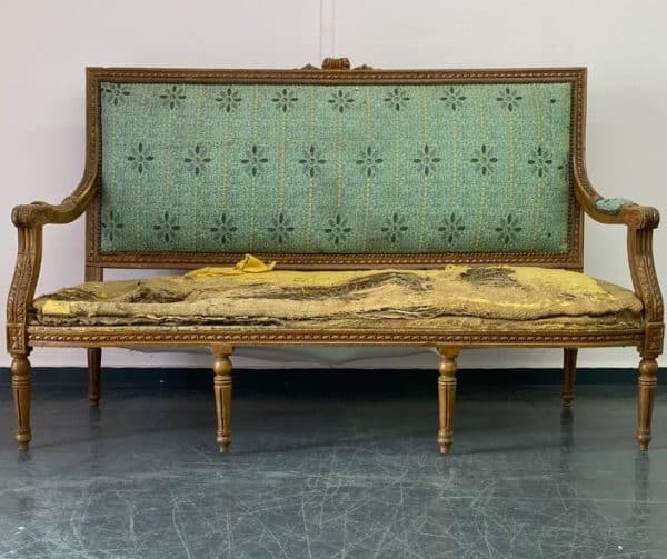 Antique sofa with 8 wooden legs in need of reupholstery