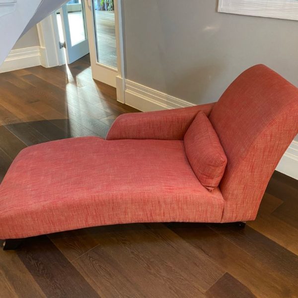 Chaise longue in a terracotta fabric before reupholstery