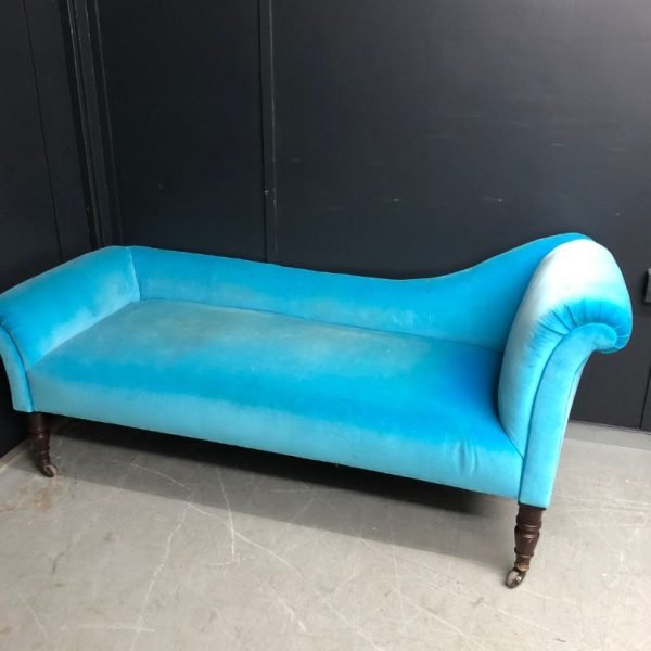 Chaise longue in a blue fabric awaiting reupholstery