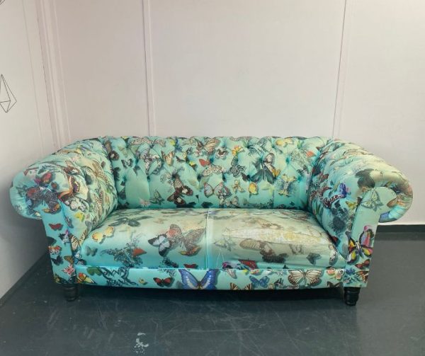 Chesterfield sofa with pale green patterned fabric awaiting reupholstery