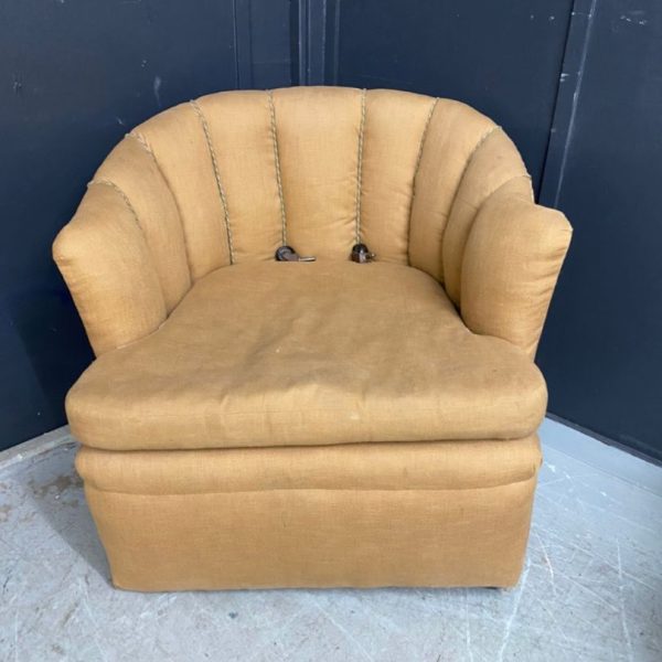 Faded neutral coloured chair in need of reupholstery