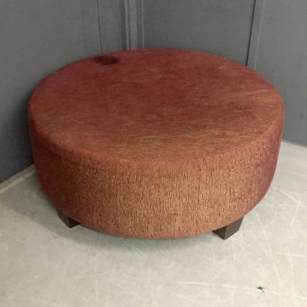 Brown fabric footstool needing reupholstery
