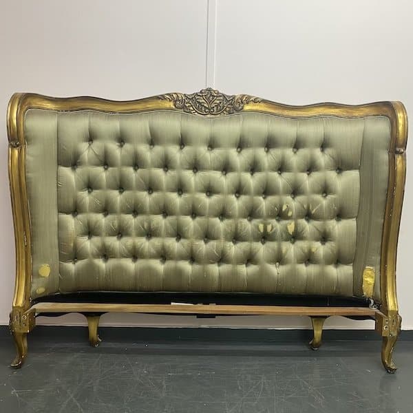 Before reupholstery of a gold framed headboard