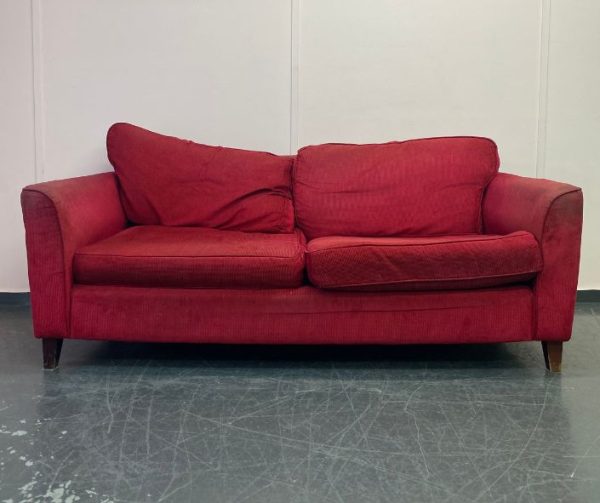 Modern red fabric sofa in need of reupholstery