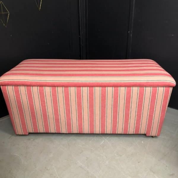 Reupholstered ottoman in a bold, striped fabric.