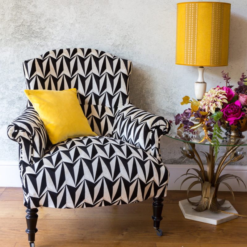 A Napoleon statement chair on monochrome black white fabric