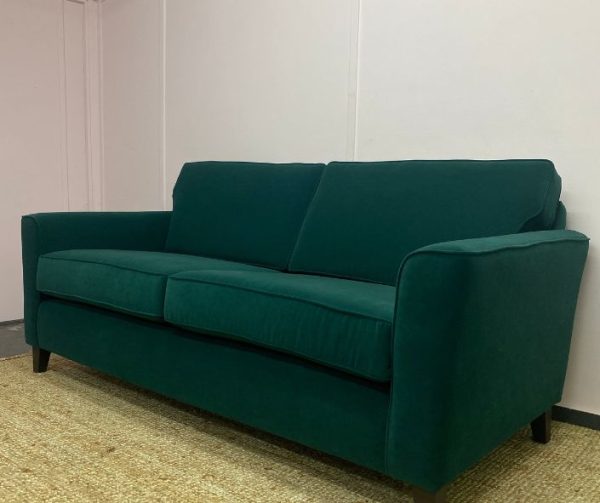 Reupholstered sofa in dark green velvet