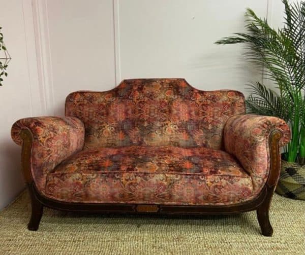 Reupholstered sofa with an antique stying and pattern fabric