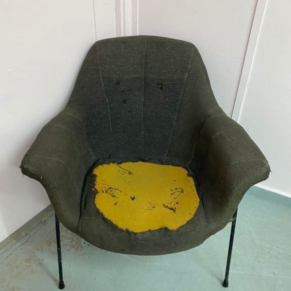 Metal framed chair showing inside stuffing awaiting reupholstery